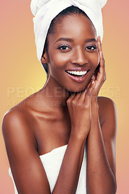 Buy stock photo Hair towel, portrait and black woman in studio for skincare, wellness or body care on orange background. Beauty, cleaning or hands on face of African female model with cosmetic, shine or glowing skin