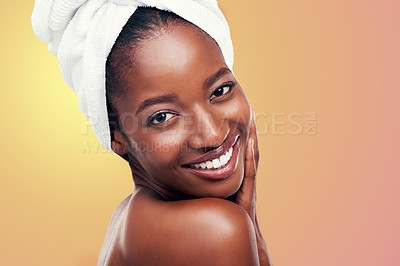 Buy stock photo Portrait, smile and black woman with hair towel in studio for skincare, wellness or body care on orange background. Beauty, cleaning and face of African female model with cosmetic, shine or soft skin