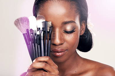 Buy stock photo Beauty, makeup and brushes, black woman in studio with cosmetic application tools and glamour. Skincare, brush and cosmetics, facial skin care glow, model with luxury contour tool on white background