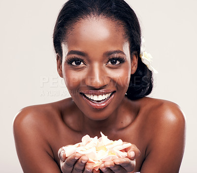 Buy stock photo Portrait, petal or black woman in studio for makeup, beauty or wellness on white background. Floral, face or African model smile with soft cosmetics, shine or organic, fun and skincare transformation