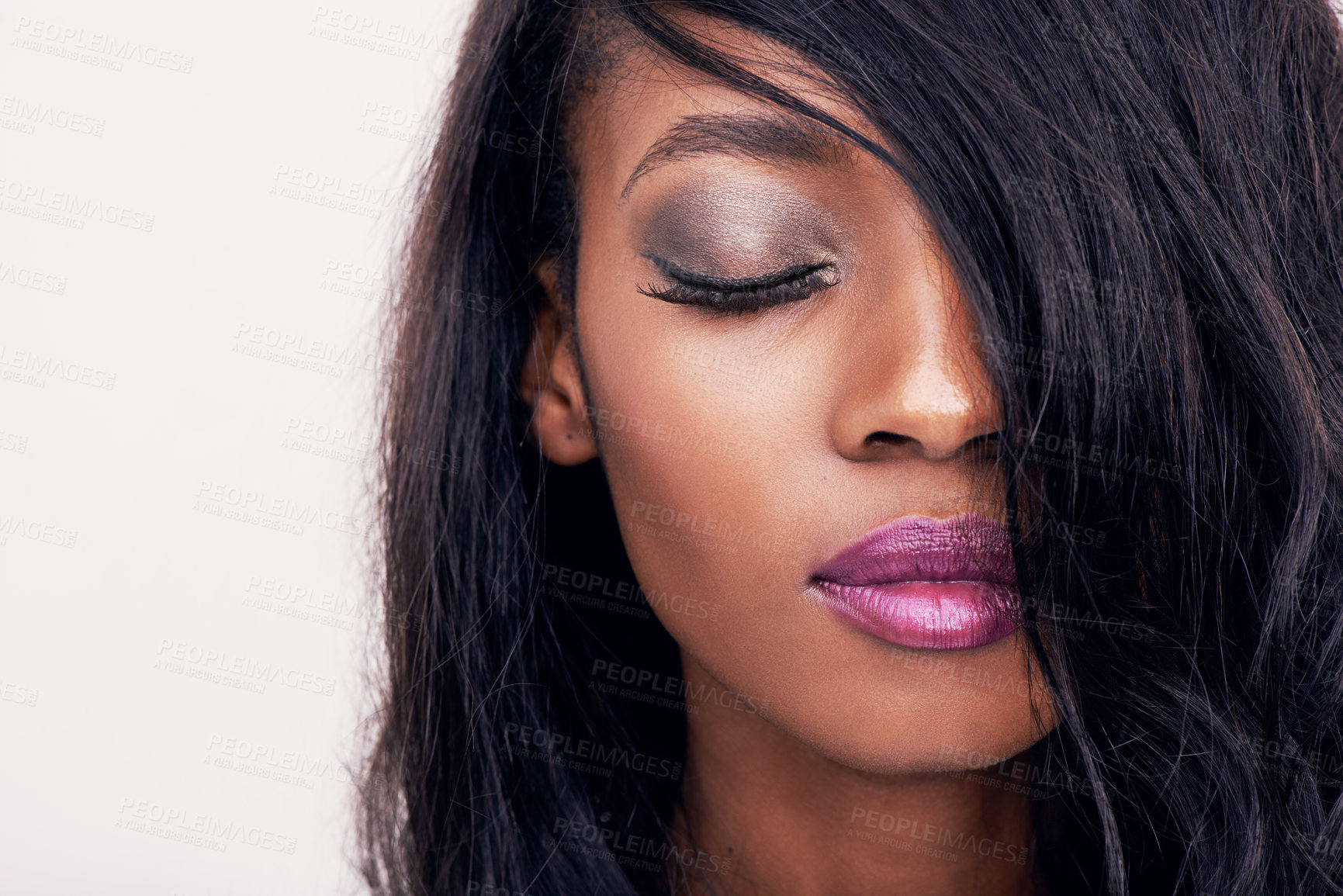 Buy stock photo Beauty, face and makeup on a black woman in studio for cosmetics, hair extension or glow. Headshot of an african female model on a white background for facial shine, skin care and luxury aesthetic