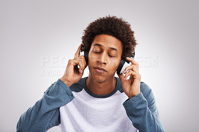 Buy stock photo Man, confident and headphones in studio background for listening to music, streaming podcast or playing radio. Black person, relax and audio relief on headsets for melody, sound and entertainment
