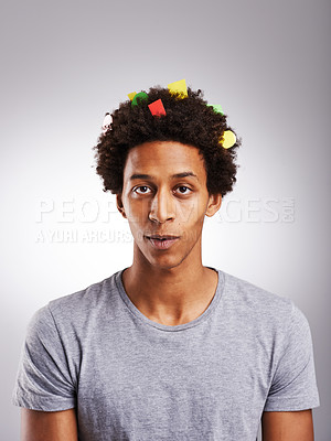 Buy stock photo Portrait, black man or confetti in funny, prank or joke of creative, fail or oops on grey background. Gen z student, guilty or paper in artistic afro looking silly, messy or comic in studio mockup