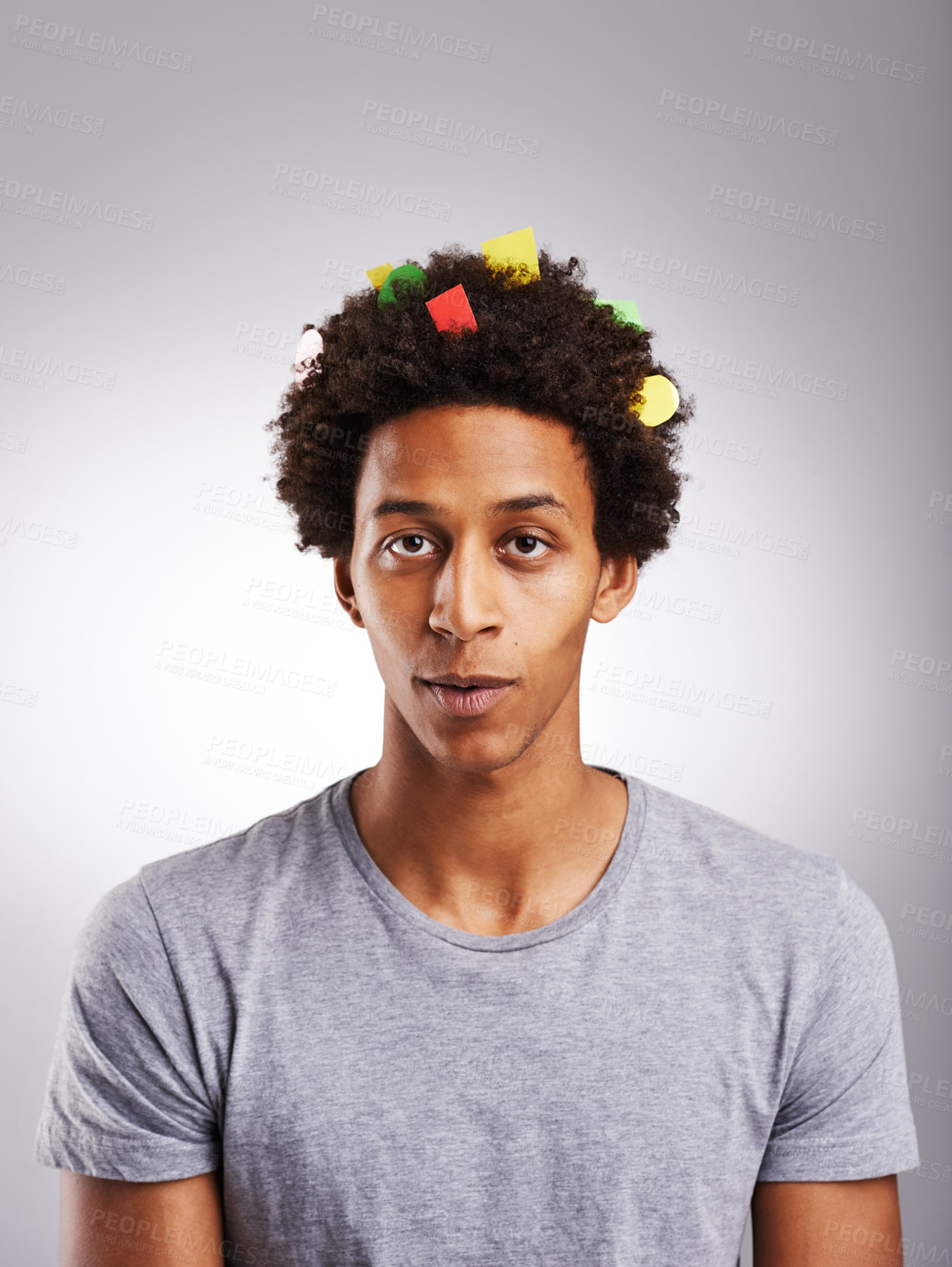 Buy stock photo Portrait, black man or confetti in funny, prank or joke of creative, fail or oops on grey background. Gen z student, guilty or paper in artistic afro looking silly, messy or comic in studio mockup