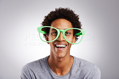 Buy stock photo Funny, big glasses and black man with a smile, happy and funky eyewear on a white studio background. Portrait, trendy and model with joy and African person with humor and silly with joke and goofy