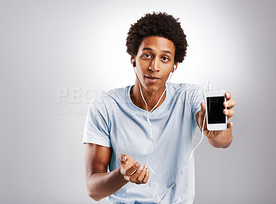 Buy stock photo Portrait, earphones or black man with phone or screen on grey background streaming music or podcast. Radio playlist, studio or African male student on mobile app mockup space for songs on headphones
