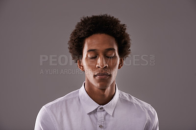 Buy stock photo Eyes closed, calm and face of black man in studio with breathing, zen or peace for anxiety. Relax, mental health and African male person with dreaming face expression isolated by gray background.
