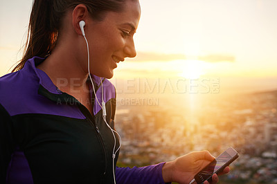 Buy stock photo Happy woman, fitness and earphones with phone in sunset for music, podcast or listening to audio in nature. Female person or runner with smile for streaming, sound or radio player during exercise