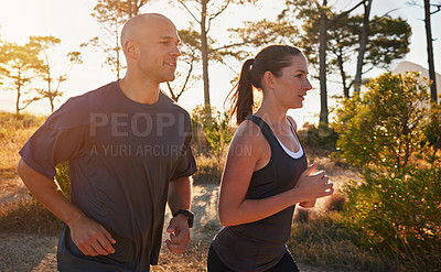 Buy stock photo Sunrise, forest and couple on trail run as workout or morning exercise for health and wellness together. Sport, man and woman runner run with athlete as training on a mountain for sports or energy