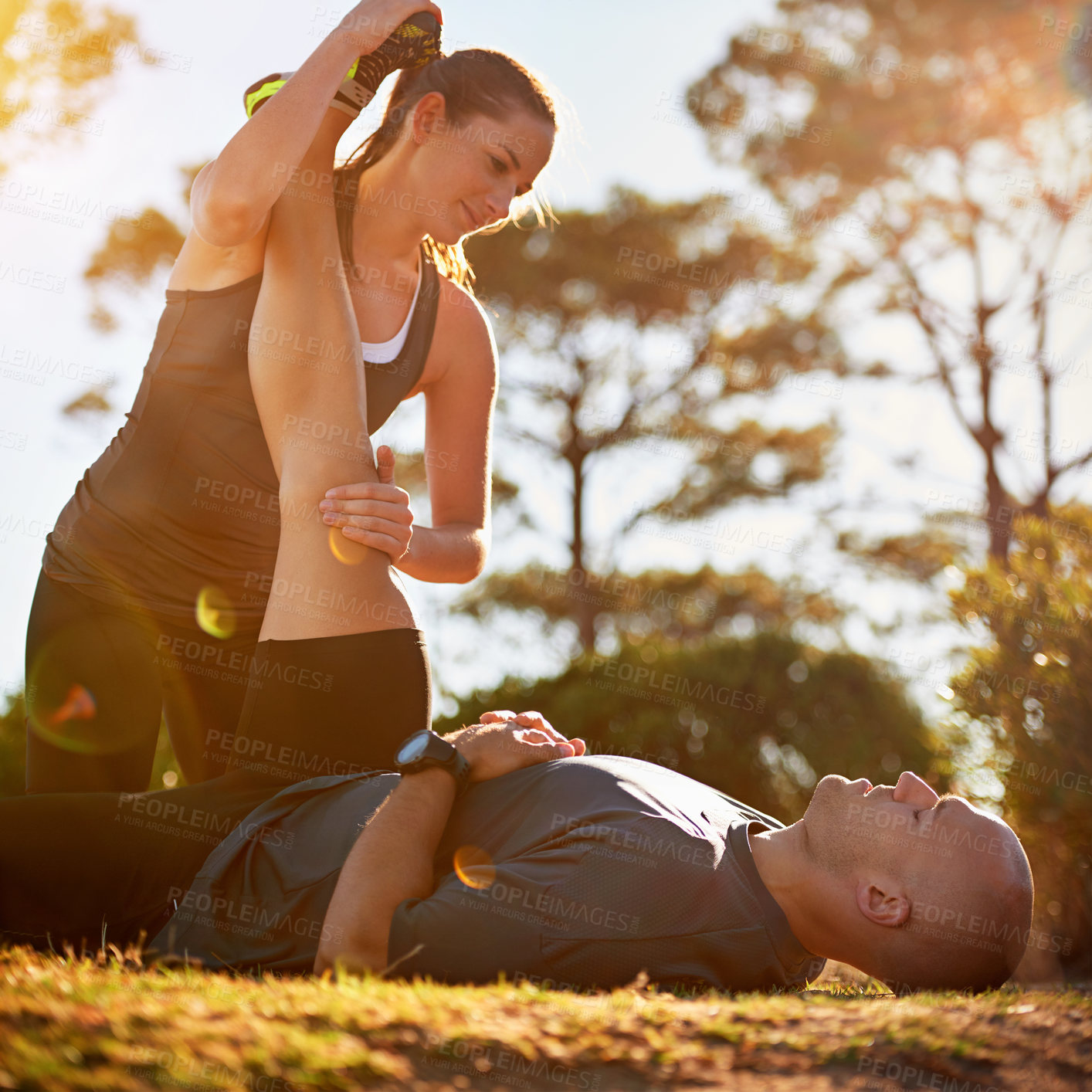 Buy stock photo Nature, help and couple stretching for fitness, workout coach and physio for healthy body. Exercise, wellness and woman with man in muscle warm up for outdoor training in morning on forest ground.