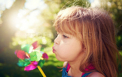 Buy stock photo Young girl, outside and pinwheel in garden, fun and enjoy freedom of outdoor and profile. Child, backyard and summer for playing, toy and windmill for nature vacation or holidays and happiness