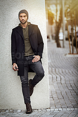 Buy stock photo Fashion, serious or man on wall in city in casual clothes or thinking of jeans for winter outdoor. Dream, planning future or stylish person in urban street in beanie, hoodie or trendy jacket in Spain