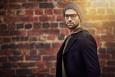 Buy stock photo Man, portrait and urban fashion by brick wall downtown for aesthetic, modern and expression for city culture. Male person, trendy winter outfit for streetwear style for creative career in retail