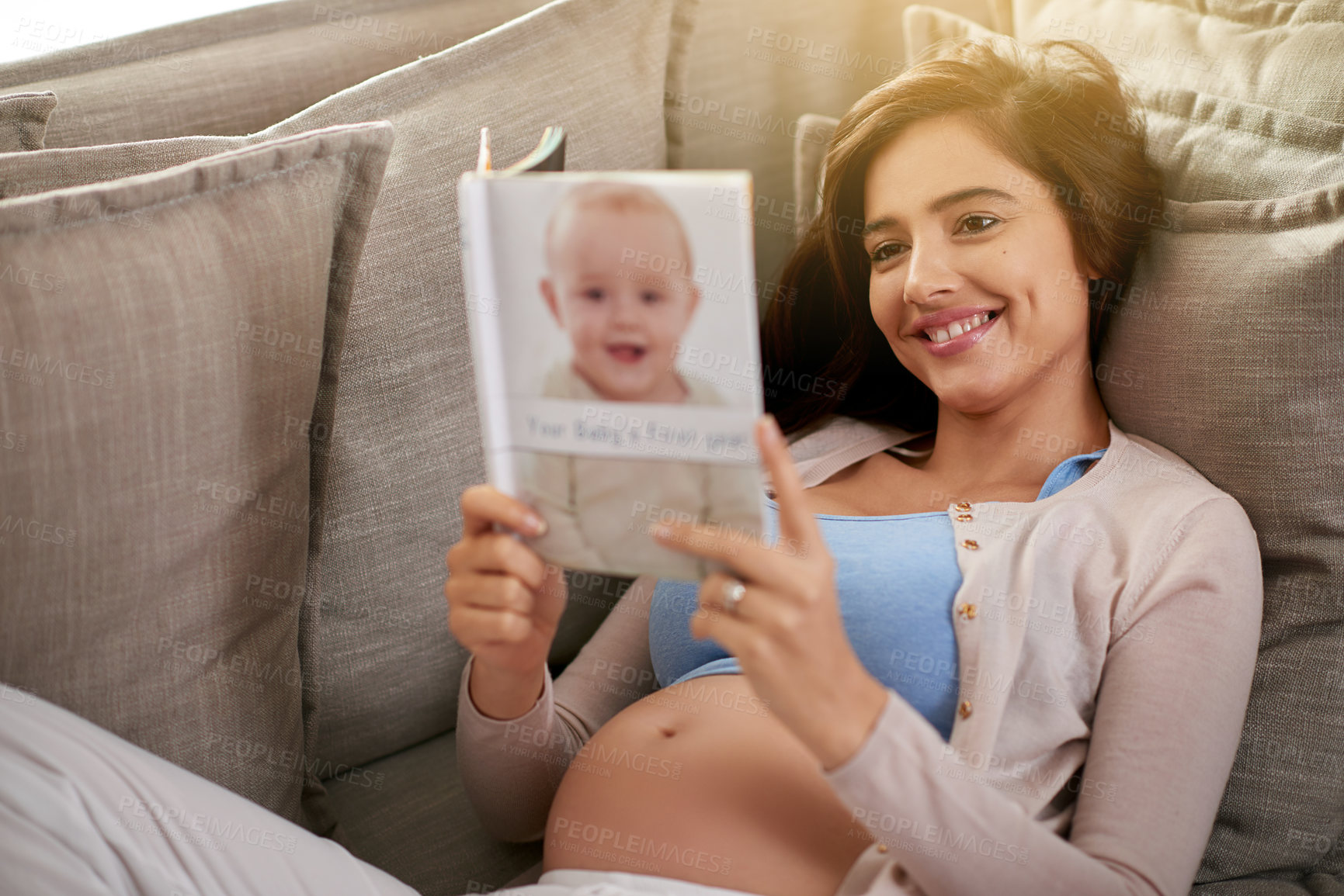 Buy stock photo Pregnant, woman and book for babies, couch and home in apartment, planning for child in lounge. House, mother and female person with smile, relax and reading, rest and love for life in living room