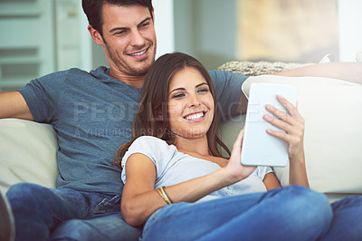 Buy stock photo Happy couple, relax and sofa with tablet for social media, entertainment or movie together at home. Man and woman laughing with smile on technology for online streaming, series or show in living room