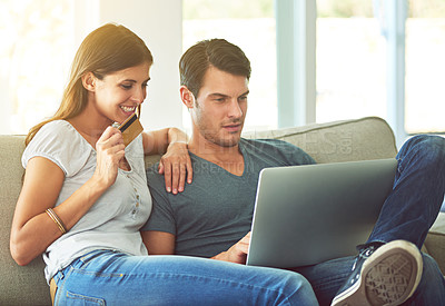 Buy stock photo Couple, laptop and credit card for online shopping on home sofa with secure fintech payment on website. A man and woman together on a couch while happy about e-commerce and internet connection