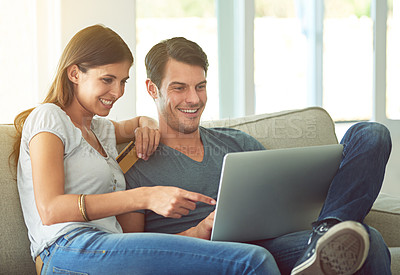 Buy stock photo Happy couple, pointing and laptop with credit card for ecommerce, payment or purchase on sofa at home. Man and woman with smile or debit on computer for choice or order in online shopping or banking