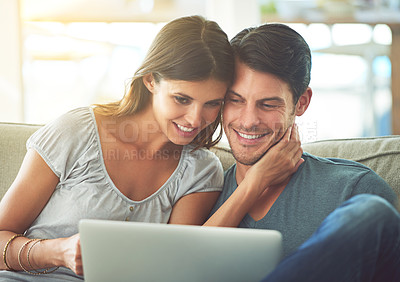 Buy stock photo Couple, home and sofa with laptop, affection and entertainment in living room with smile and laugh. Man, woman and couch with embrace, relax and love while browsing at tech in lounge at house 
