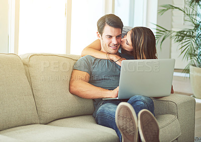 Buy stock photo Laptop, kiss and woman hugging man on sofa networking on social media, website or internet. Happy, love and female person embracing husband reading online blog with computer in living room at home.