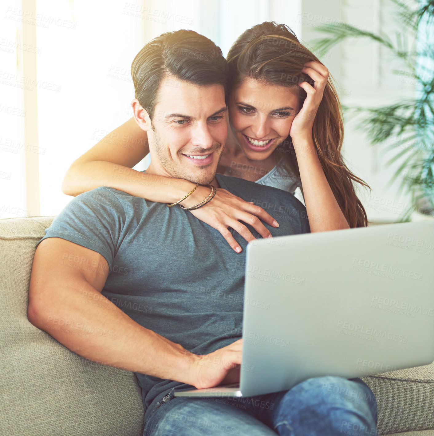 Buy stock photo Laptop, smile and woman hugging husband on sofa networking on social media, website or internet. Happy, love and female person embracing man reading online blog with computer in living room at home.