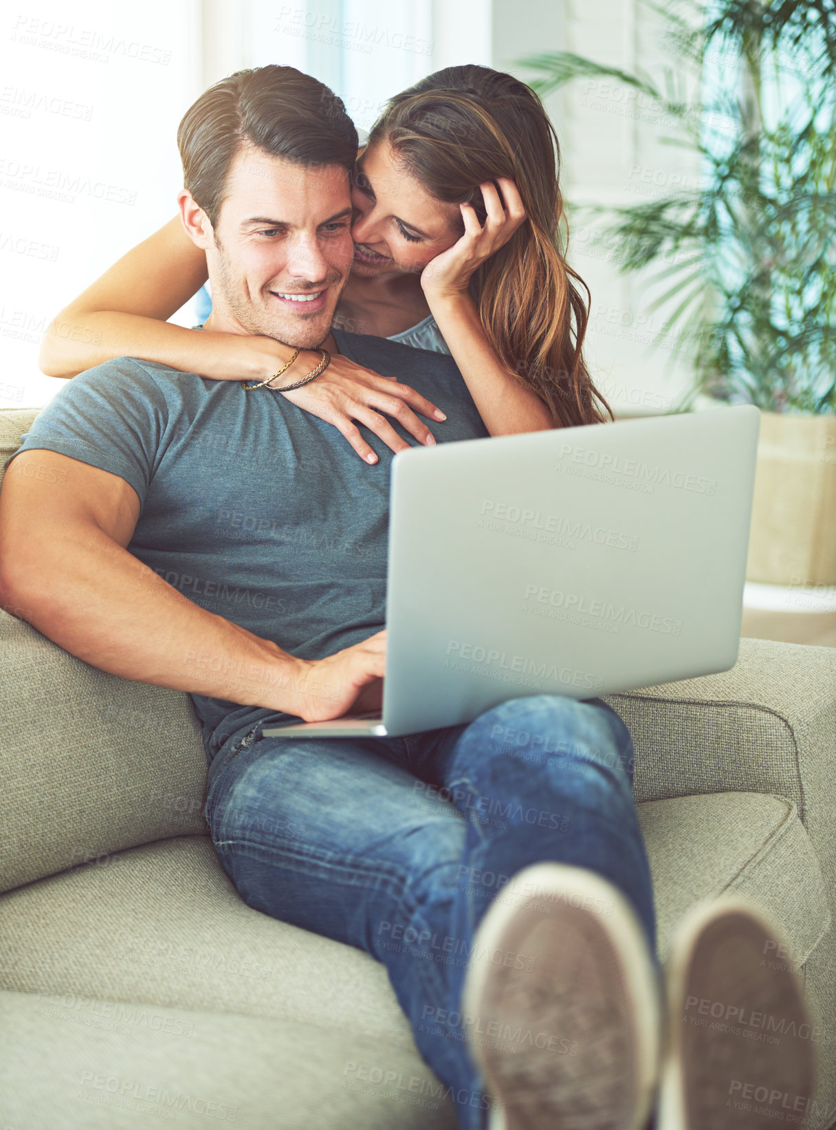 Buy stock photo Laptop, bonding and woman hugging man on sofa networking on social media, website or internet. Happy, love and female person embracing husband reading online blog with computer in living room at home