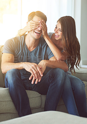 Buy stock photo A young woman covering her husband's eyes for a surprise