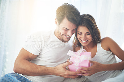 Buy stock photo Love, gift and valentines day with a couple in a bedroom of their home together for a romantic celebration. Birthday, box or present with a young man and woman bonding in bed to celebrate in a house