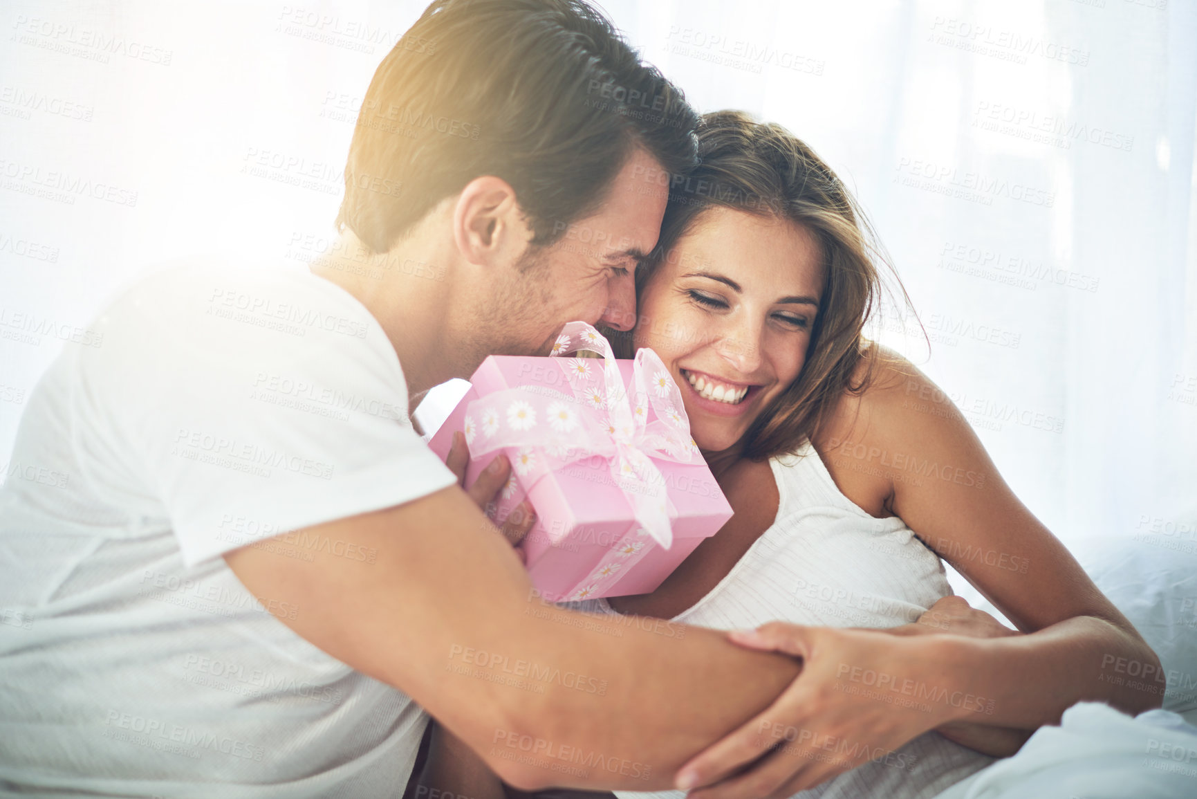 Buy stock photo Shot of a loving husband giving his wife a gift