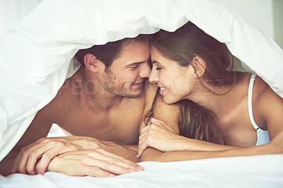 Buy stock photo Love, couple and happy in bed, waking up and bonding in a bedroom together, flirting and romantic. Romance, man and woman relax, intimate and resting at hotel for valentines day, anniversary or bond