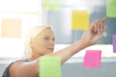 Buy stock photo Woman, glass and board with pointing, ideas and notes for planning, proposal and thinking for development. Person, wall and paper with brainstorming process, decision and choice with modern office