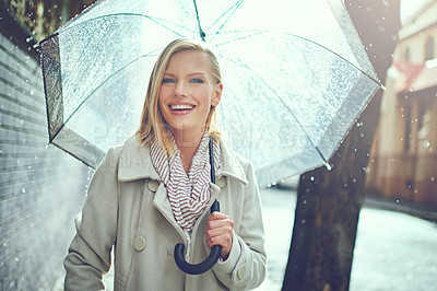 Buy stock photo Cropped portrait of an attractive young woman walking in the rain