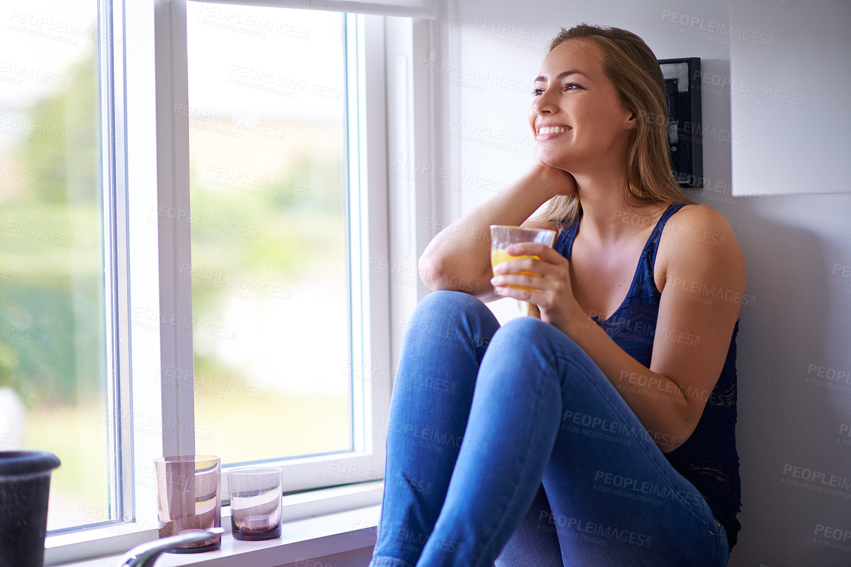Buy stock photo Kitchen counter, smile and girl with juice in home, detox and nutrition for breakfast in morning. Thinking, happy and woman with glass, healthy and vegan with drink of orange, protein and diet