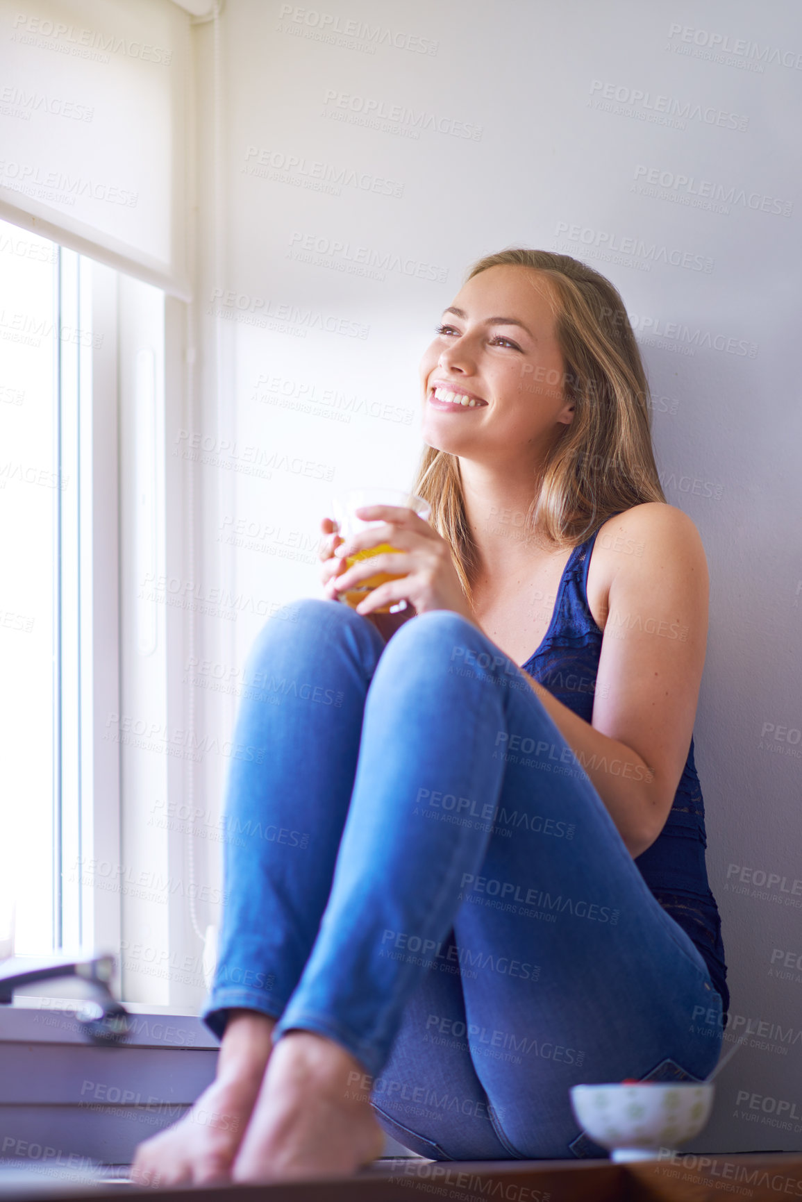 Buy stock photo Home, thinking and woman with orange juice, window and smile with ideas, relax and happiness in lounge. Apartment, person and girl with nutrition, smoothies and break with decision, peace and calm