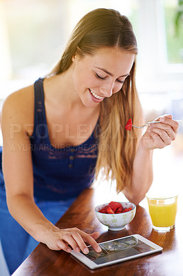 Buy stock photo Breakfast, smile and tablet with woman eating strawberry bowl in kitchen of home for health. Diet, food or nutrition and happy person in apartment with technology for hunger or weekend wellness