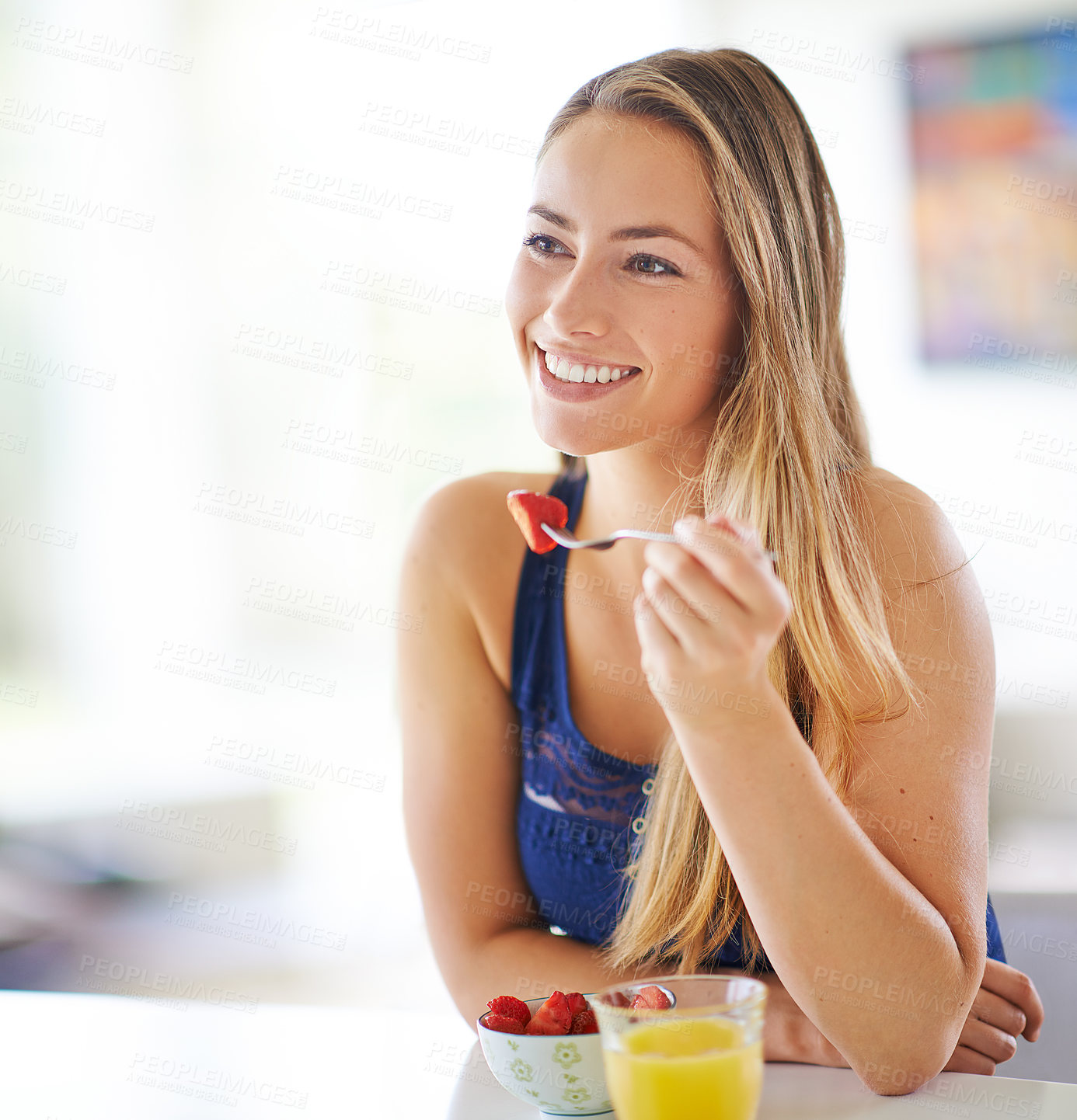 Buy stock photo Woman, eating and strawberry in kitchen for breakfast or diet, morning with healthy meal at table. Female person, fruit and nutrition with happiness in home for wellness, natural food for energy
