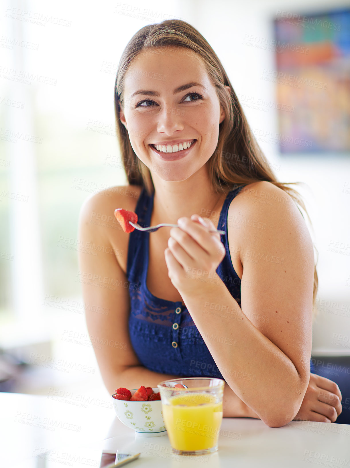 Buy stock photo Woman, eating and strawberry in home for breakfast or diet, morning with healthy meal at table. Female person, fruit and nutrition with happiness in kitchen for wellness, natural food for energy