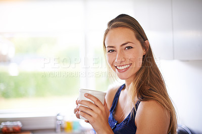Buy stock photo Portrait of a young woman having a cup of coffee at home