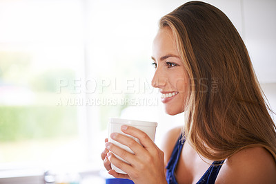Buy stock photo Shot of a young woman having a cup of coffee at home