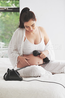 Buy stock photo Pregnant woman, telephone and relax on bed for communication, happiness and contact in bedroom. Mother, smile and conversation in house for care, connection and phone on tummy for voice or sound. 