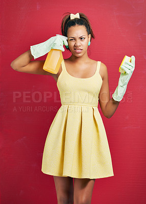 Buy stock photo Woman, housewife and spray bottle or unhappy in studio with hygiene cleaning or annoyed, red background or mockup. Female person, dress and maintenance service with chemical, confused or thinking