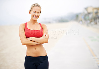 Buy stock photo Portrait of a young woman in sportswear standing at the beach