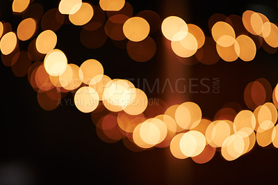 Buy stock photo Shot of bright lights blurred in the background of a dark setting
