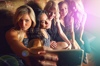 Buy stock photo Shot of a group of young women taking a selfie together in a nightclub