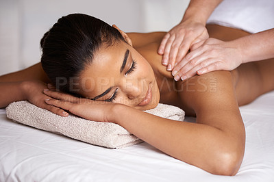 Buy stock photo Cropped shot of a young woman enjoying a massage at a spa