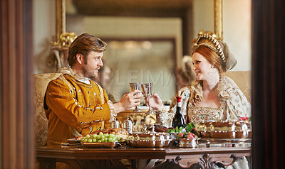 Buy stock photo Royal, man and woman with luxury for dinner, wine and toast together for wedding and coronation. King and queen with smile for food with alcohol to drink in palace, happiness and joy for marriage