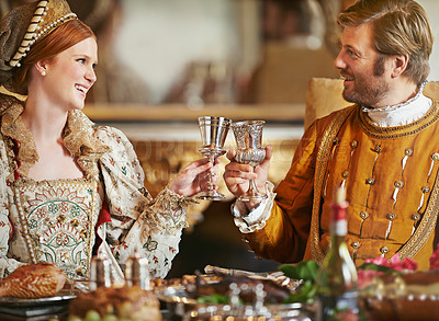 Buy stock photo Royal, king and queen with food and wine for luxury, toast and happiness together for wedding night. Noble, man and woman with smile for wealth in marriage, princess or girl with husband in palace