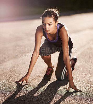 Buy stock photo Shot of a young woman in the starting position for a run