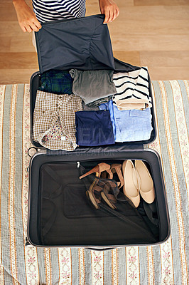 Buy stock photo Hands, travel and person packing suitcase in bedroom of home for holiday or vacation from above. Clothes, getting ready and luggage with tourist bag on bed of apartment, hotel or person for getaway