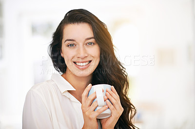 Buy stock photo Portrait of a happy young woman enjoying a cup of coffee