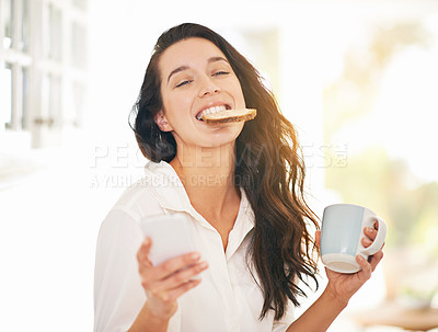Buy stock photo Shot of a young woman enjoying breakfast in her kitchen